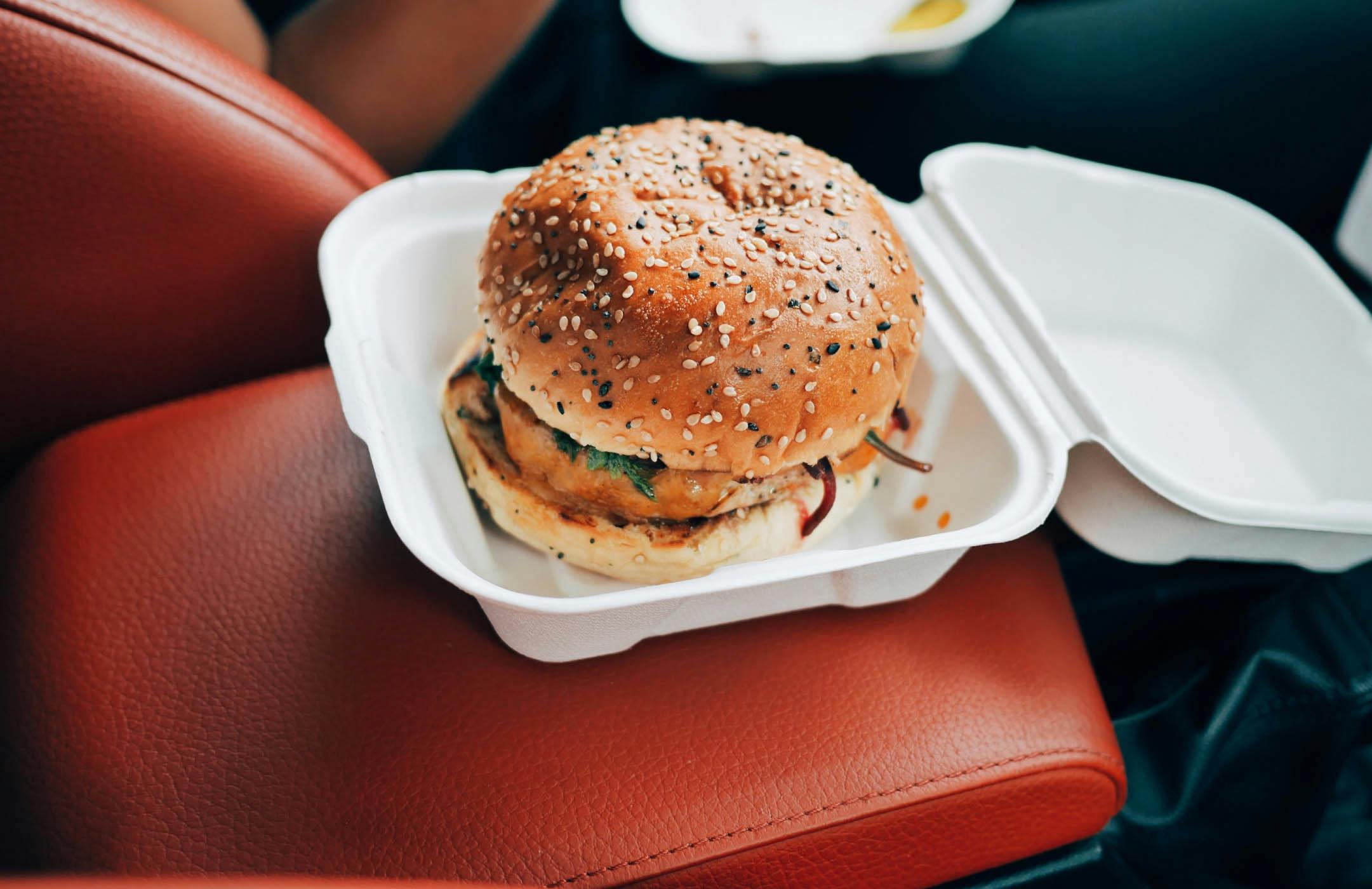 Photograph of hamburger in takeout container
